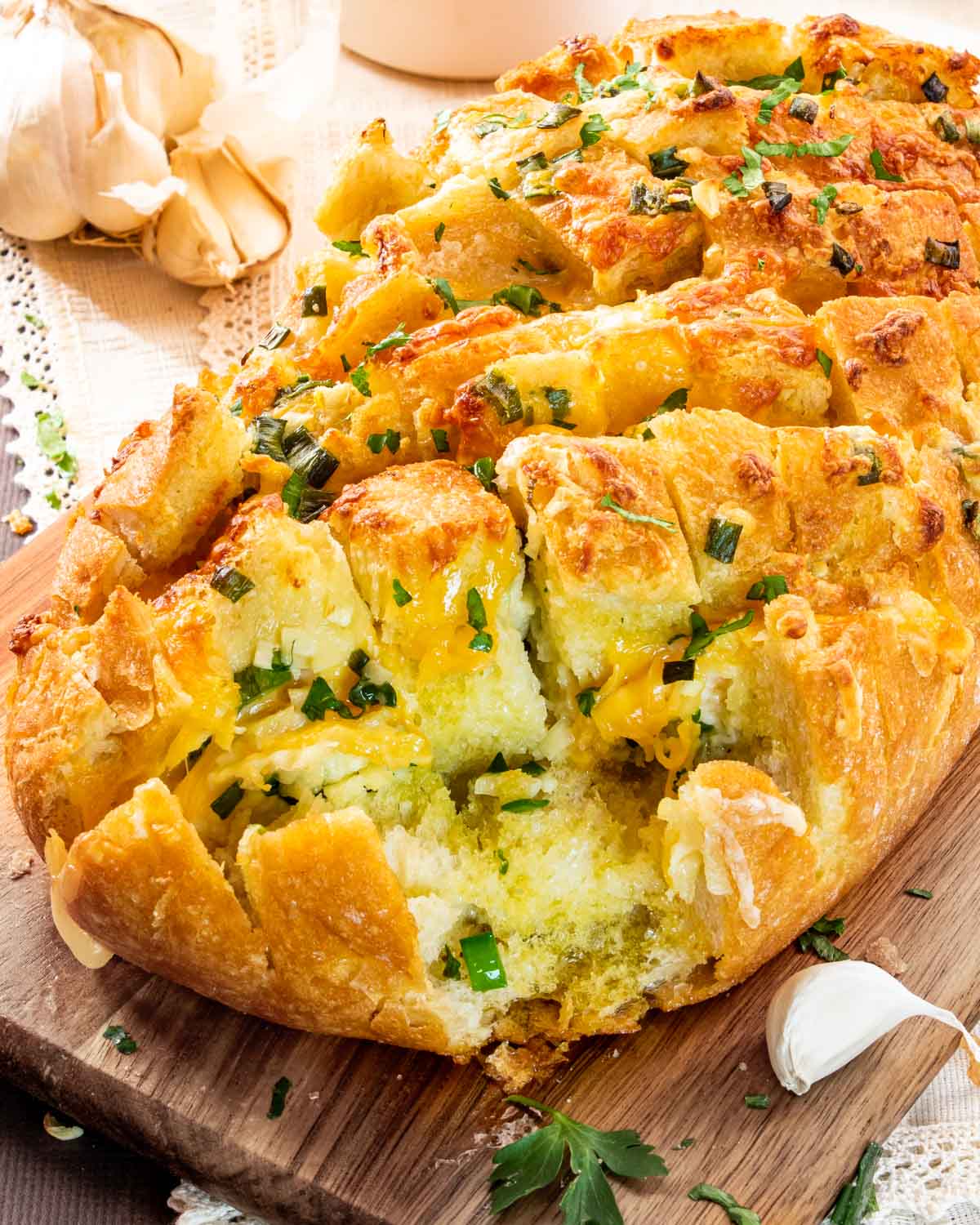 cheese pull apart bread that was made in an air fryer on a cutting board.