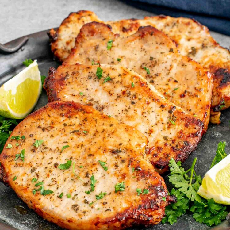 freshly air fried ranch pork chops on a metal platter.