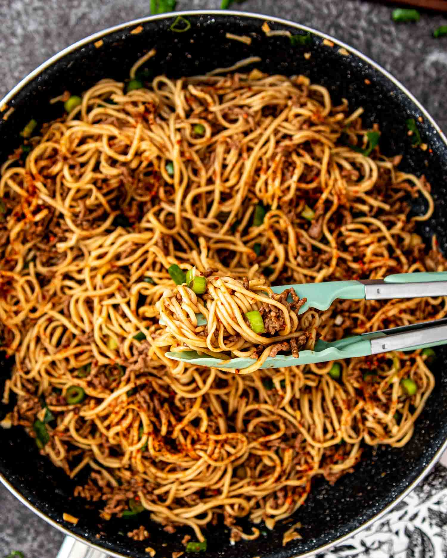 freshly made asian ground beef noodles in a skillet.