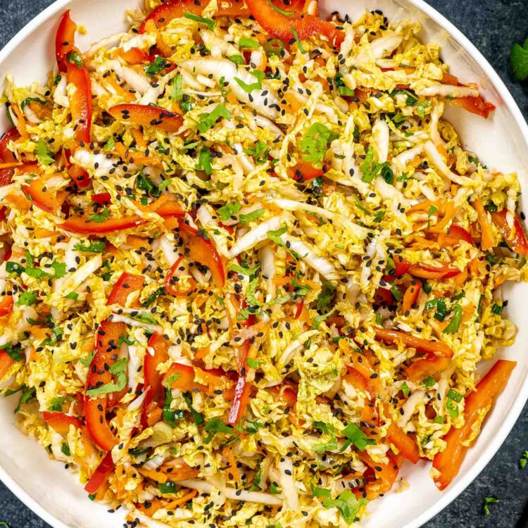 asian style slaw freshly made in a white bowl.