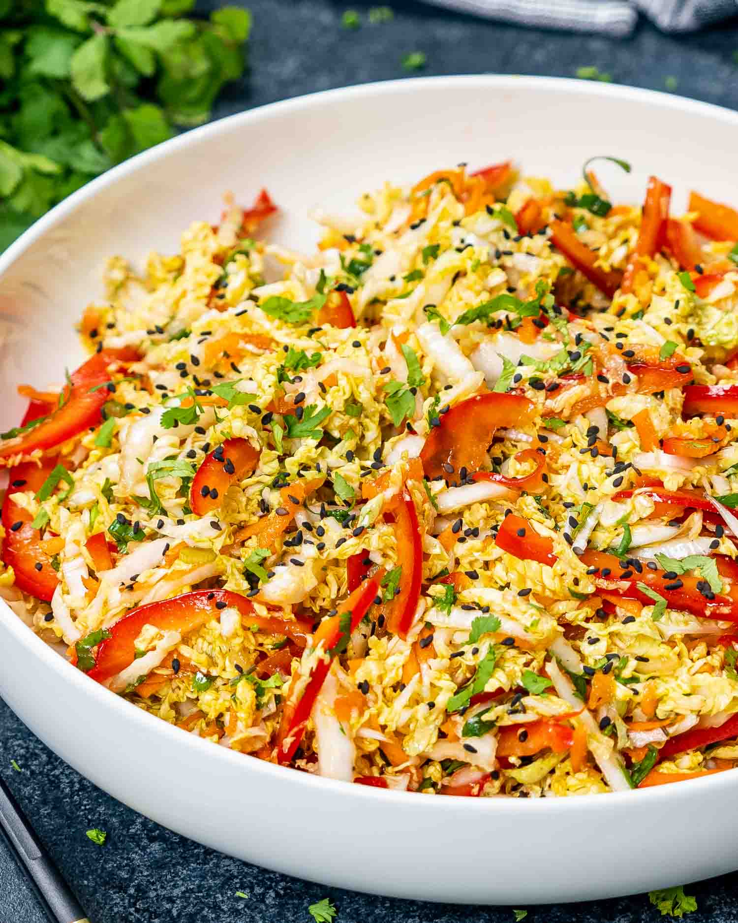 asian style slaw freshly made in a white bowl.