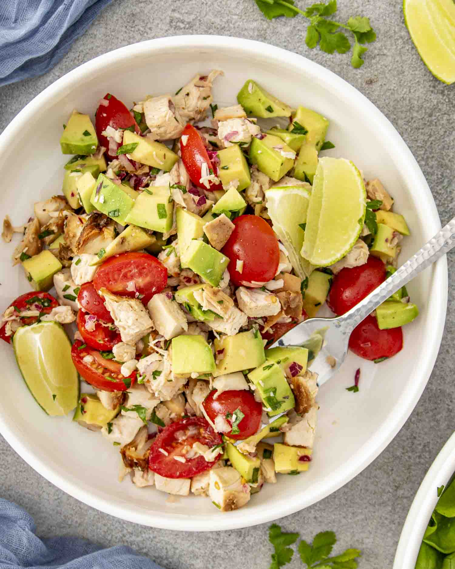 a serving of avocado chicken salad in a white bowl.