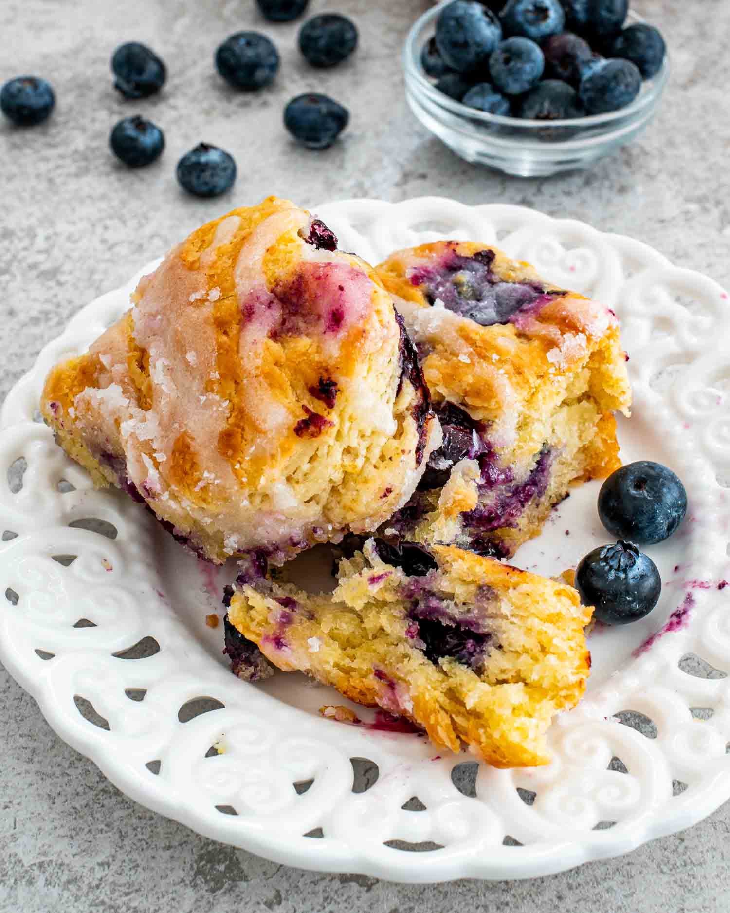 2 blueberry biscuits on a white plate.