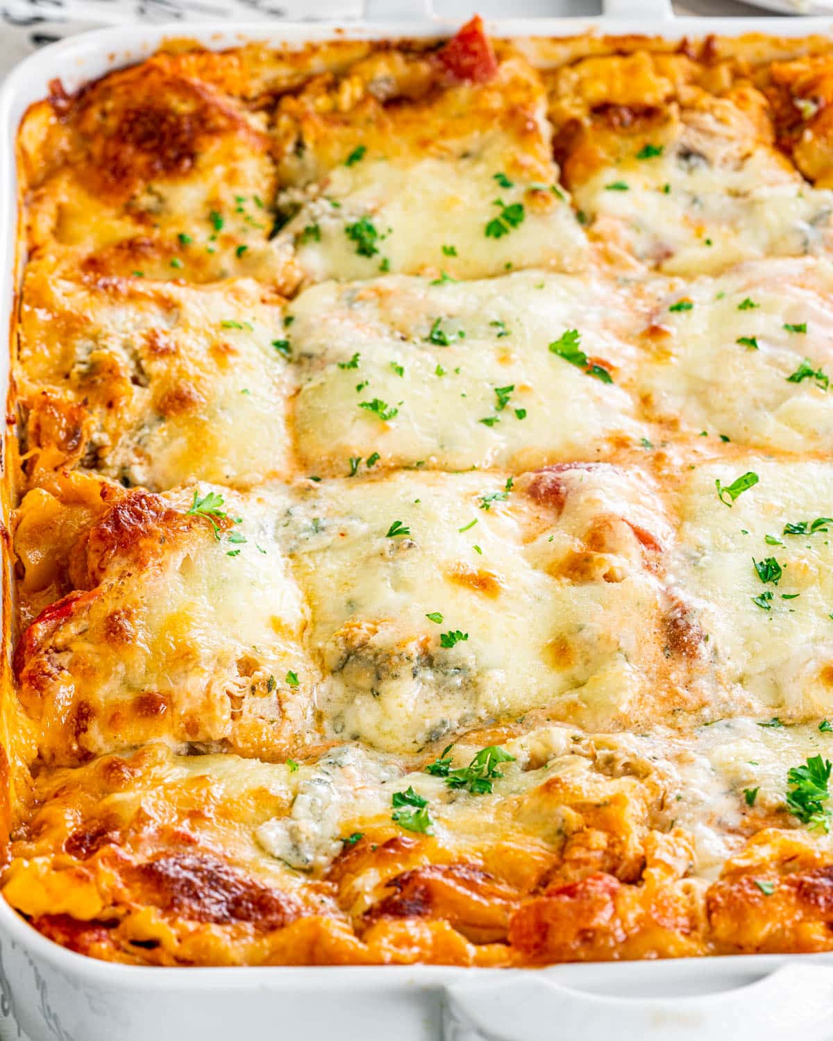 lasagna in a white casserole dish