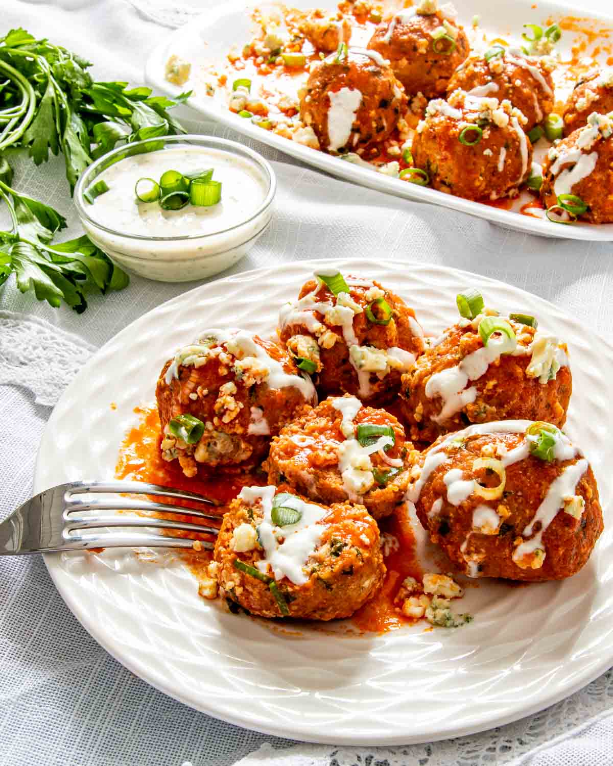 buffalo chicken meatballs on a white plate.
