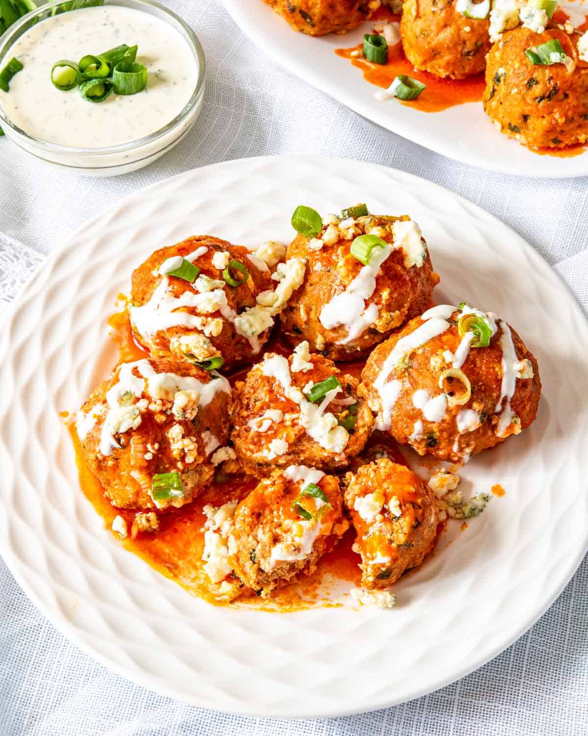 buffalo chicken meatballs on a white plate.