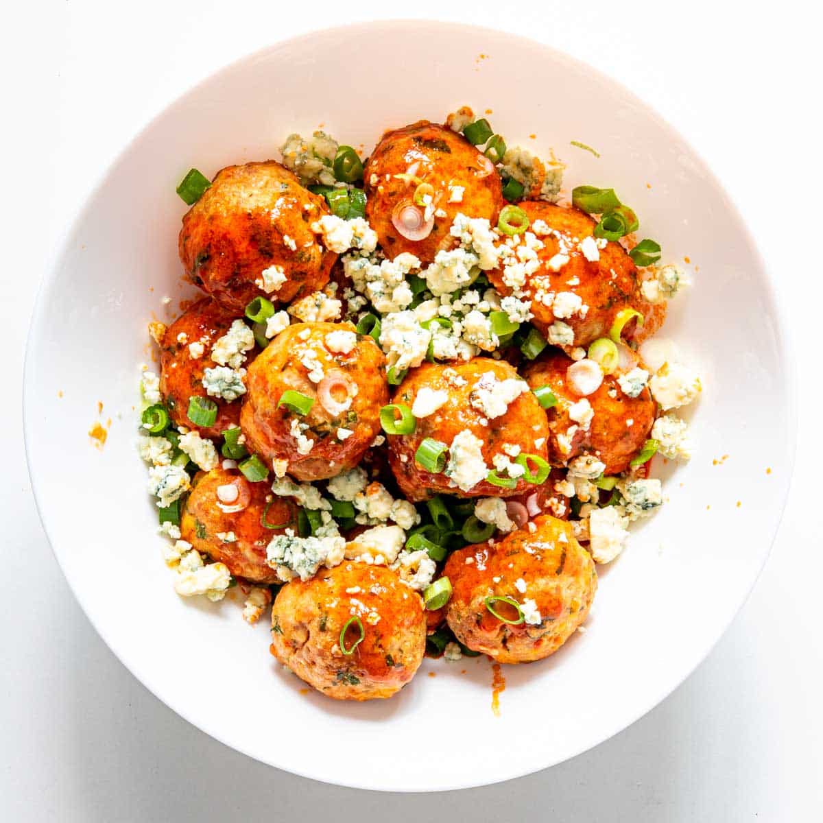 buffalo chicken meatballs on a white plate.