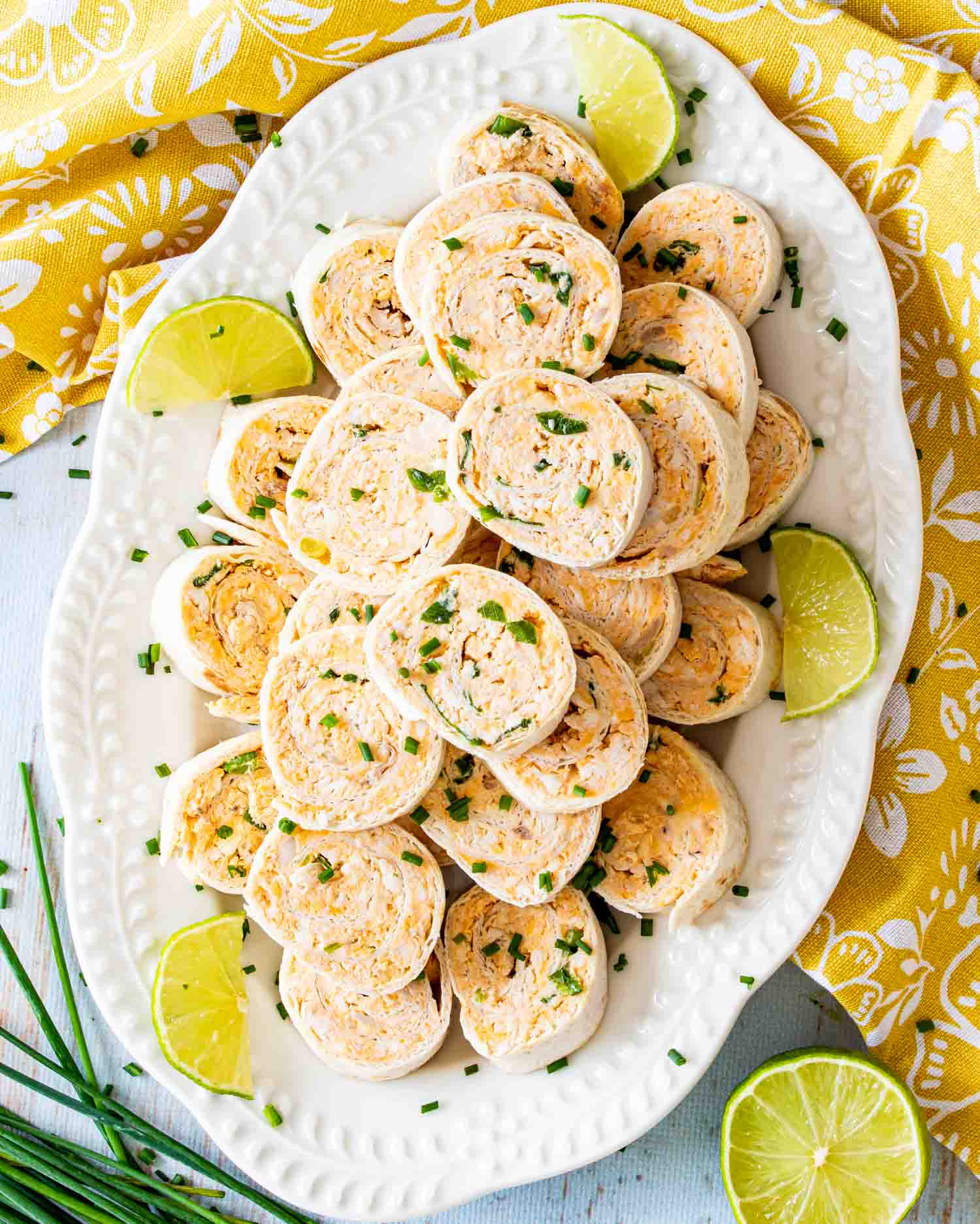 buffalo chicken pinwheels on a white platter.