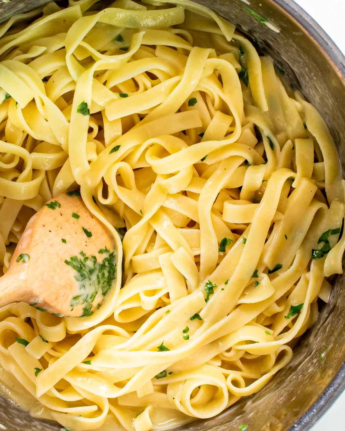 freshly made buttered noodles in a saucepan.