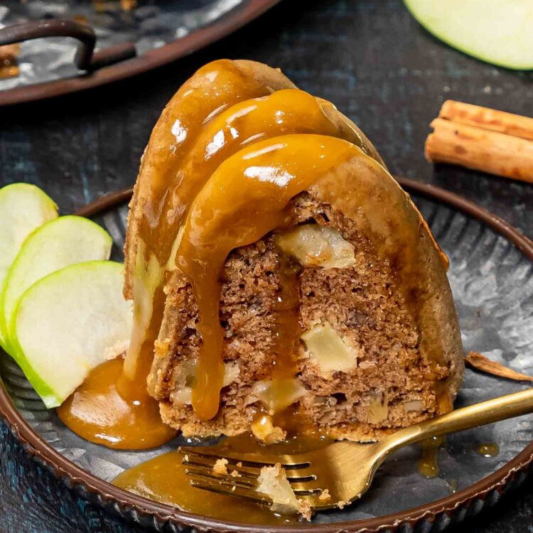 a slice of caramel apple cake on a plate.