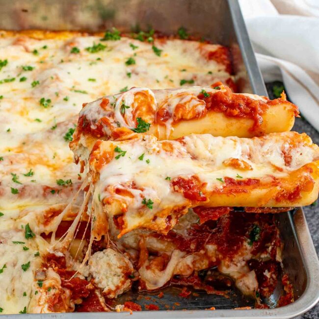 freshly made cheese stuffed manicotti in a casserole dish.