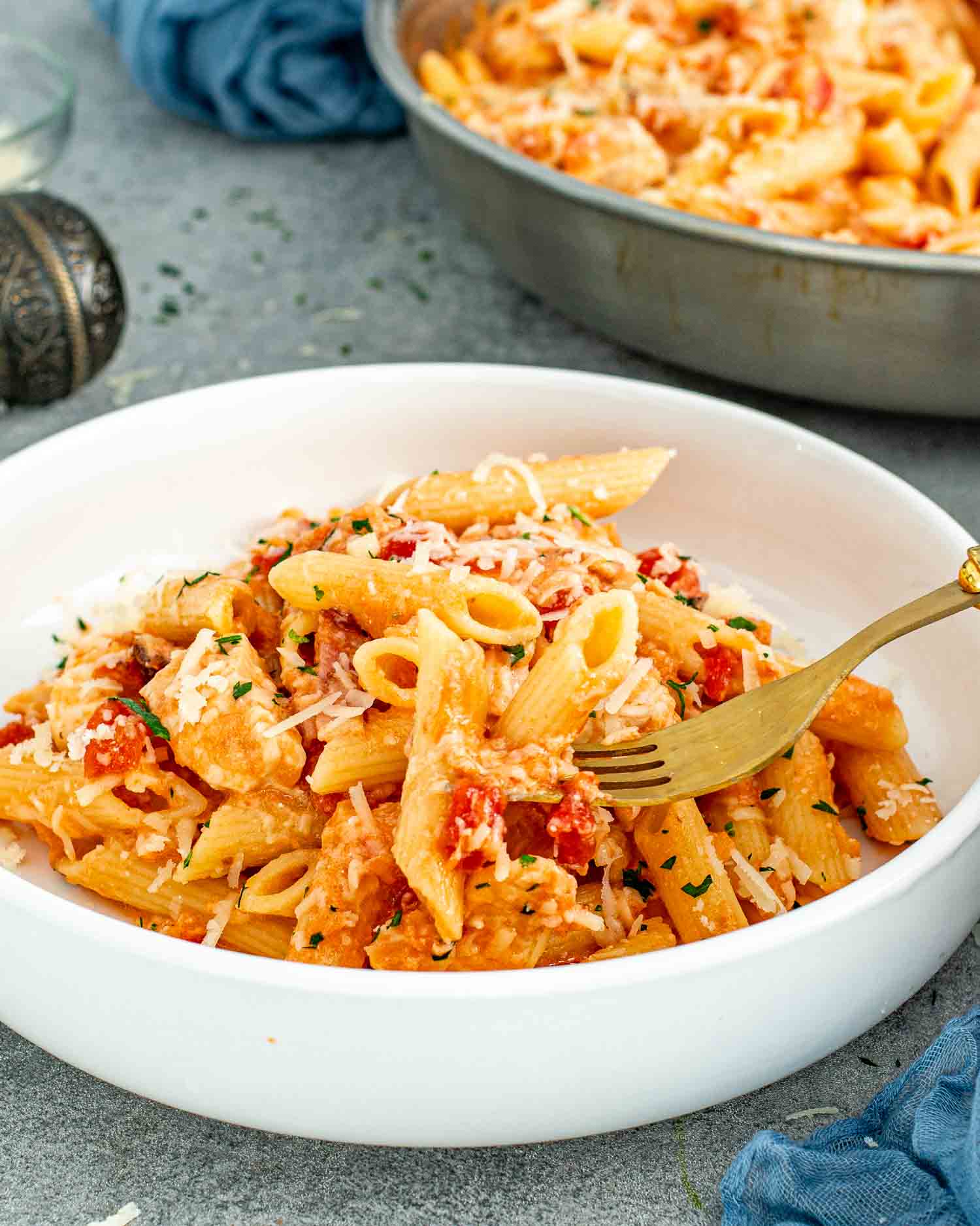 a serving of chicken bacon pasta in a white bowl.