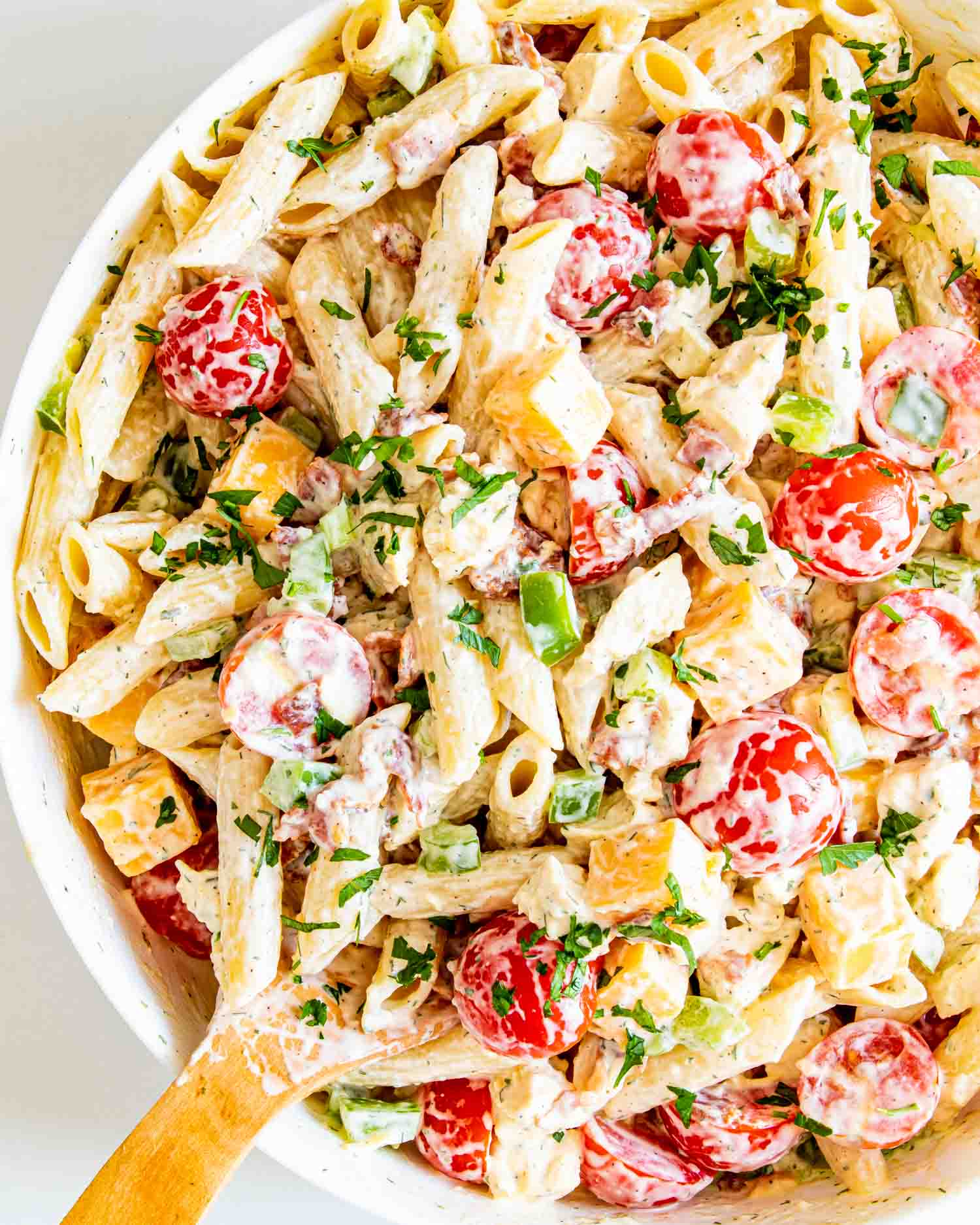 chicken club pasta salad in a white bowl.