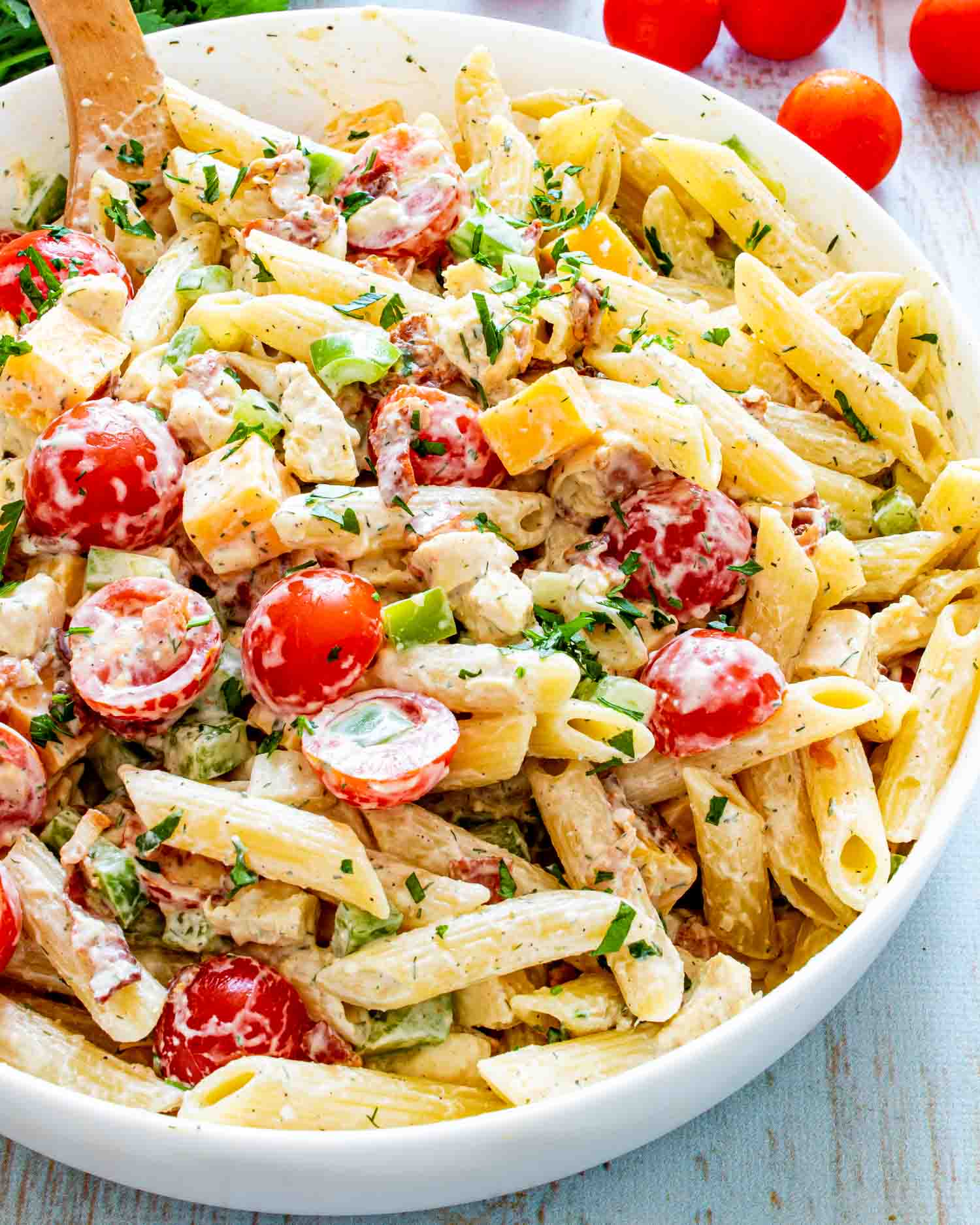 chicken club pasta salad in a white bowl.