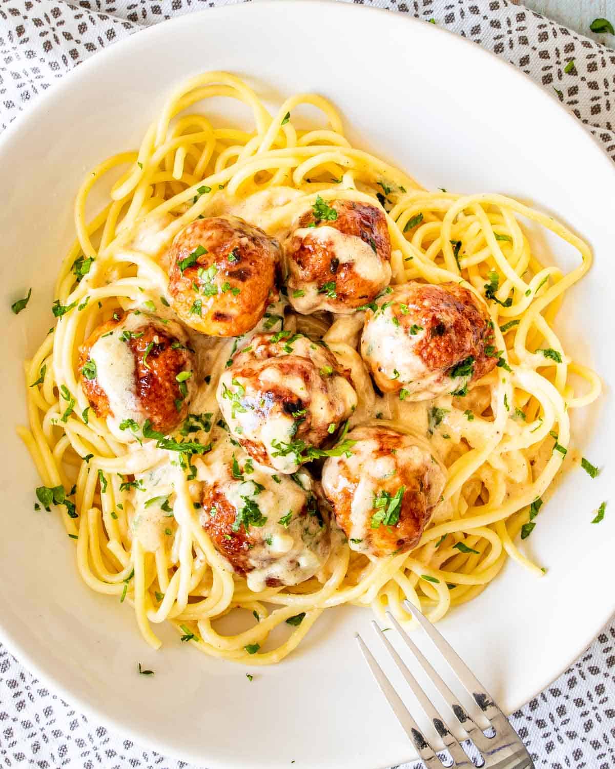 chicken meatballs with alfredo sauce and spaghetti.