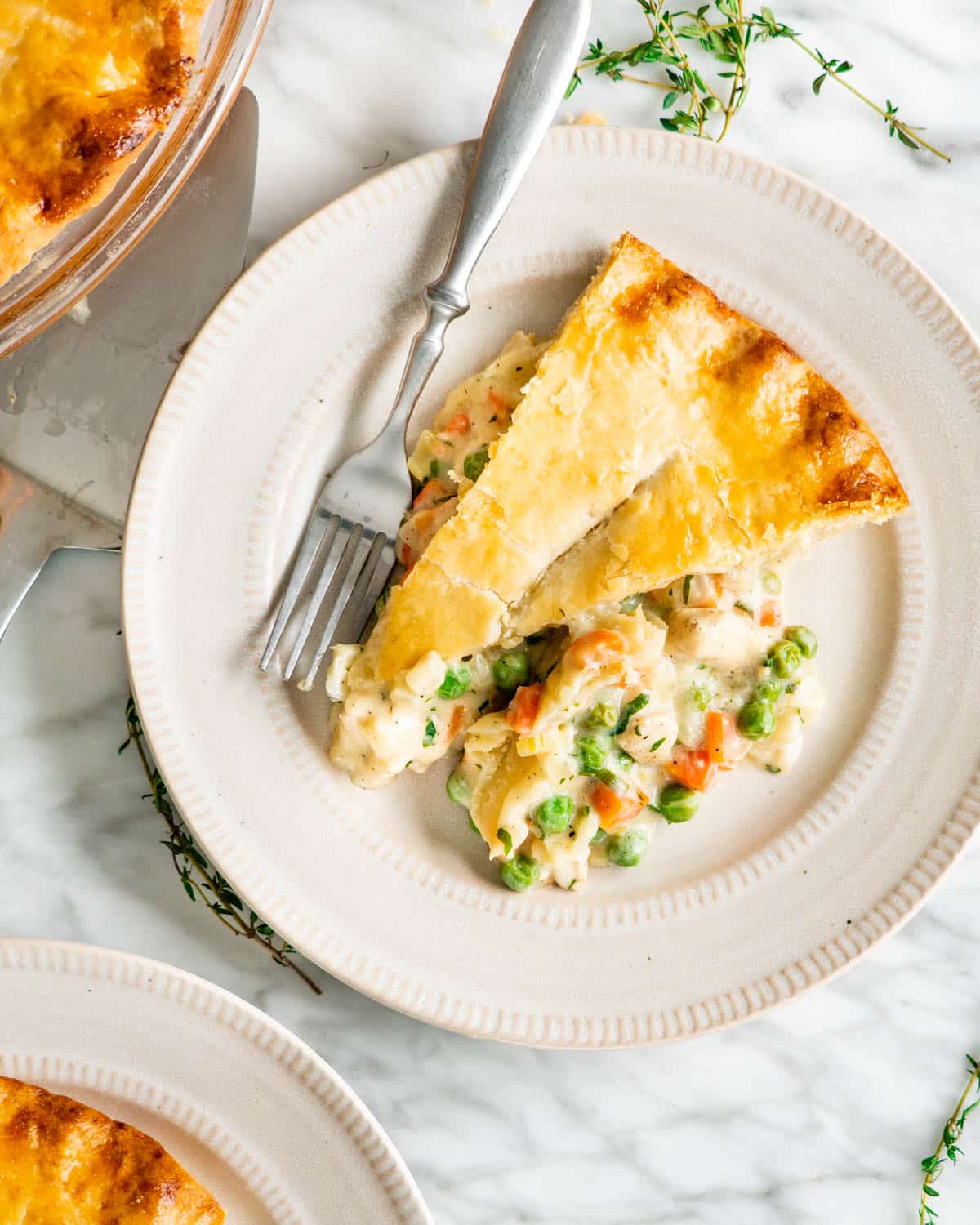 overhead shot of chicken pot pie slice on a beige plate