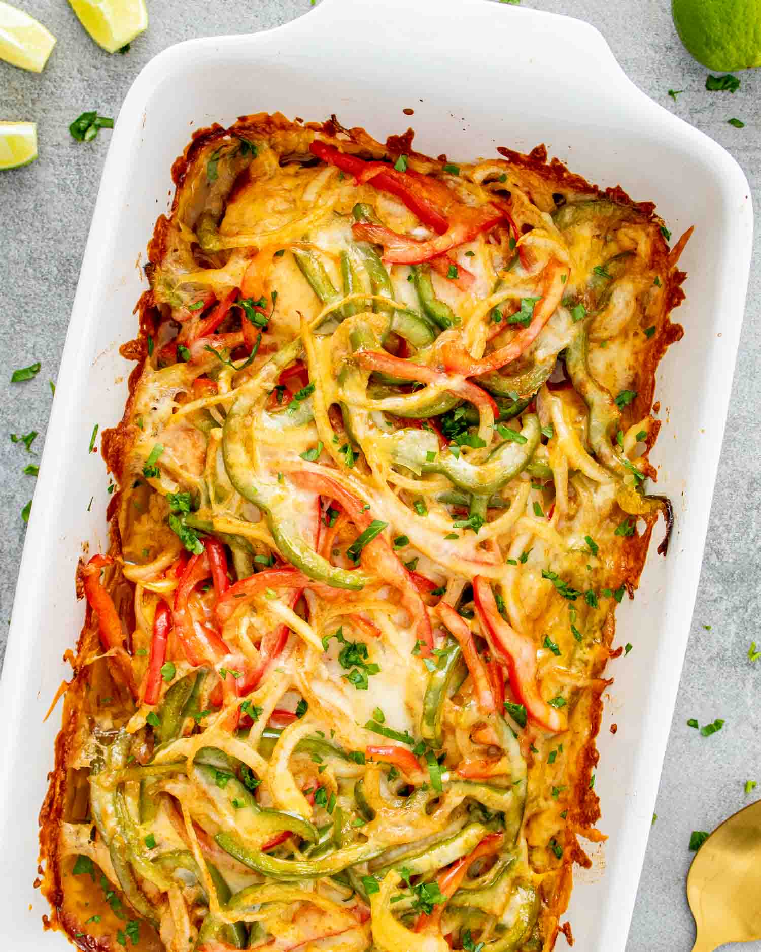 fajita chicken casserole in a white casserole dish fresh out of the oven.