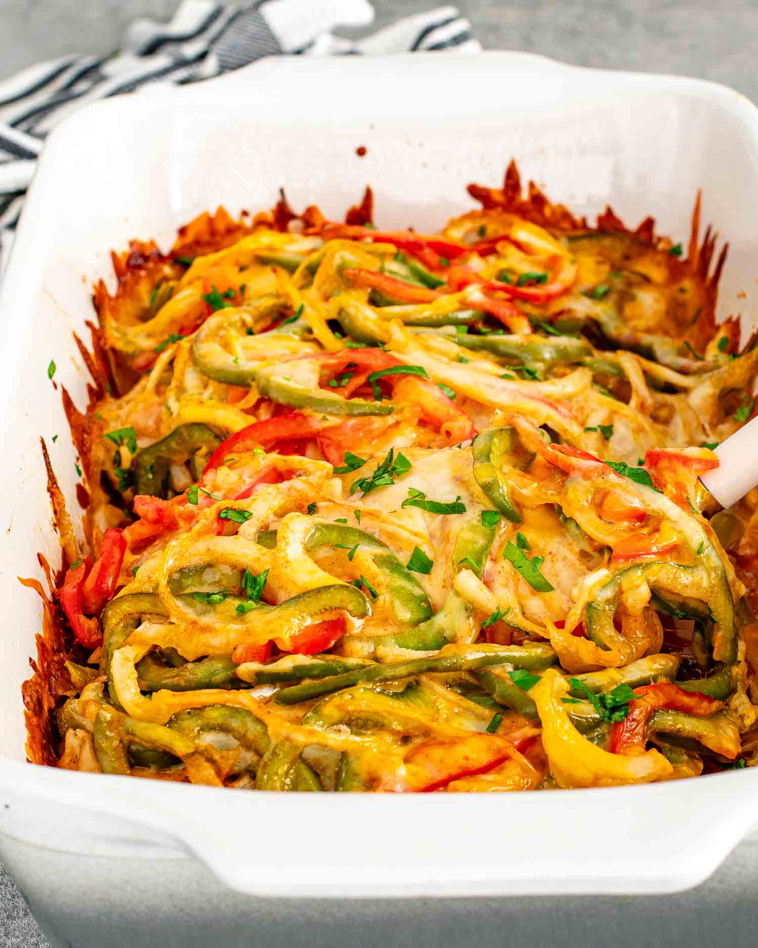 fajita chicken casserole in a white casserole dish fresh out of the oven.