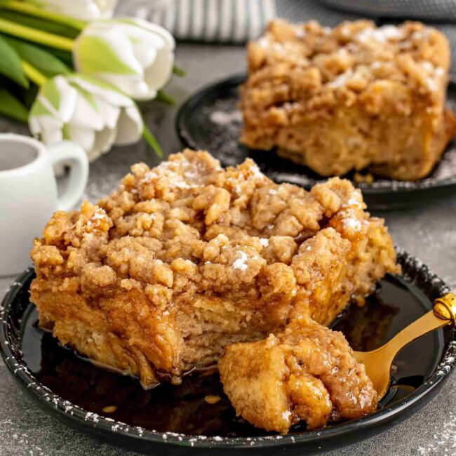 a slice of French toast casserole on a black plate.