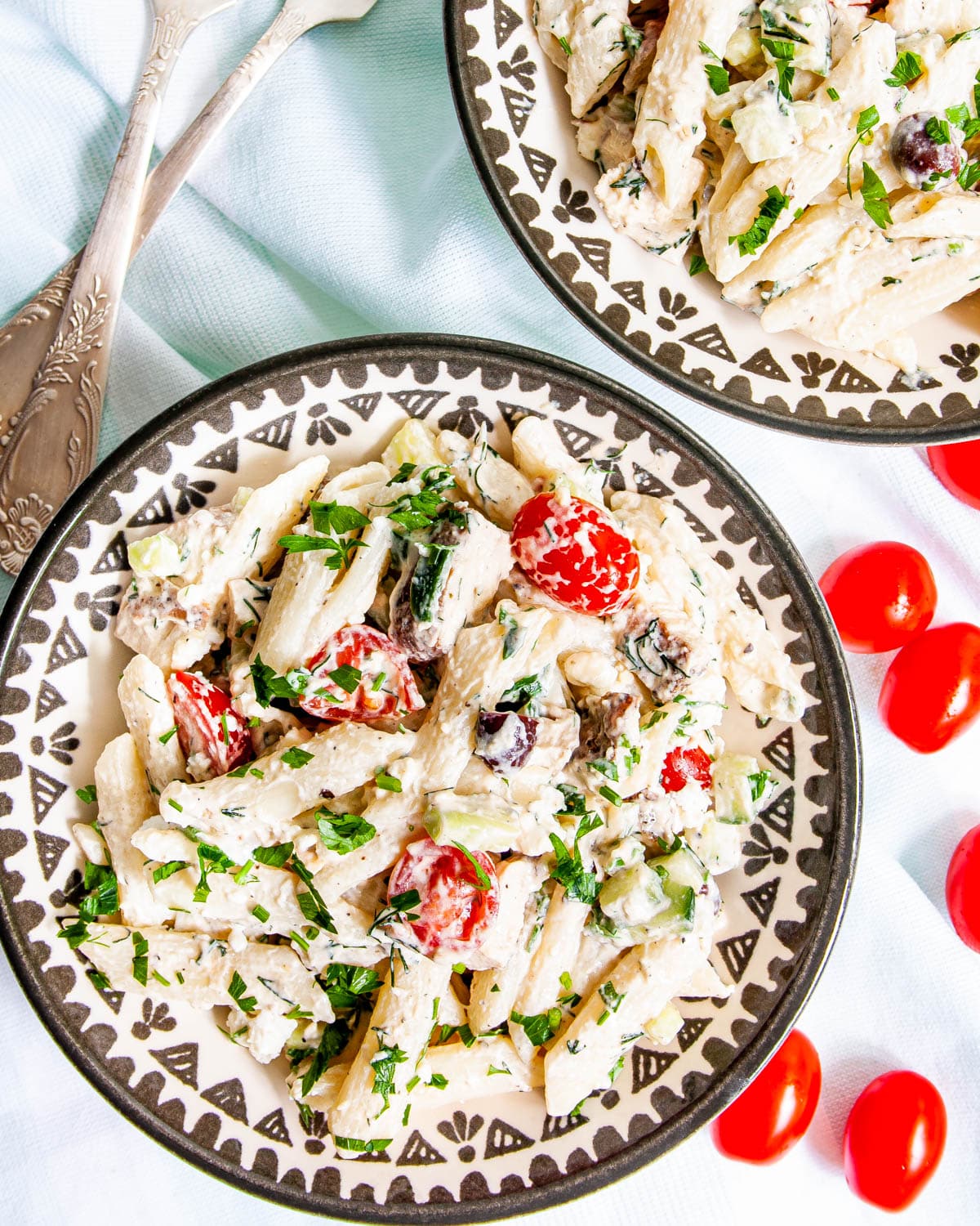 overhead shot of two plates with chicken pasta