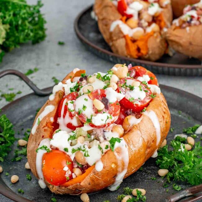 mediterranean stuffed sweet potatoes on a metal plate.