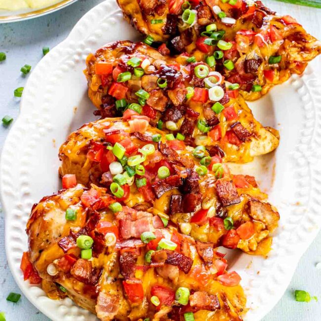 4 pieces of monterey chicken on a white platter.