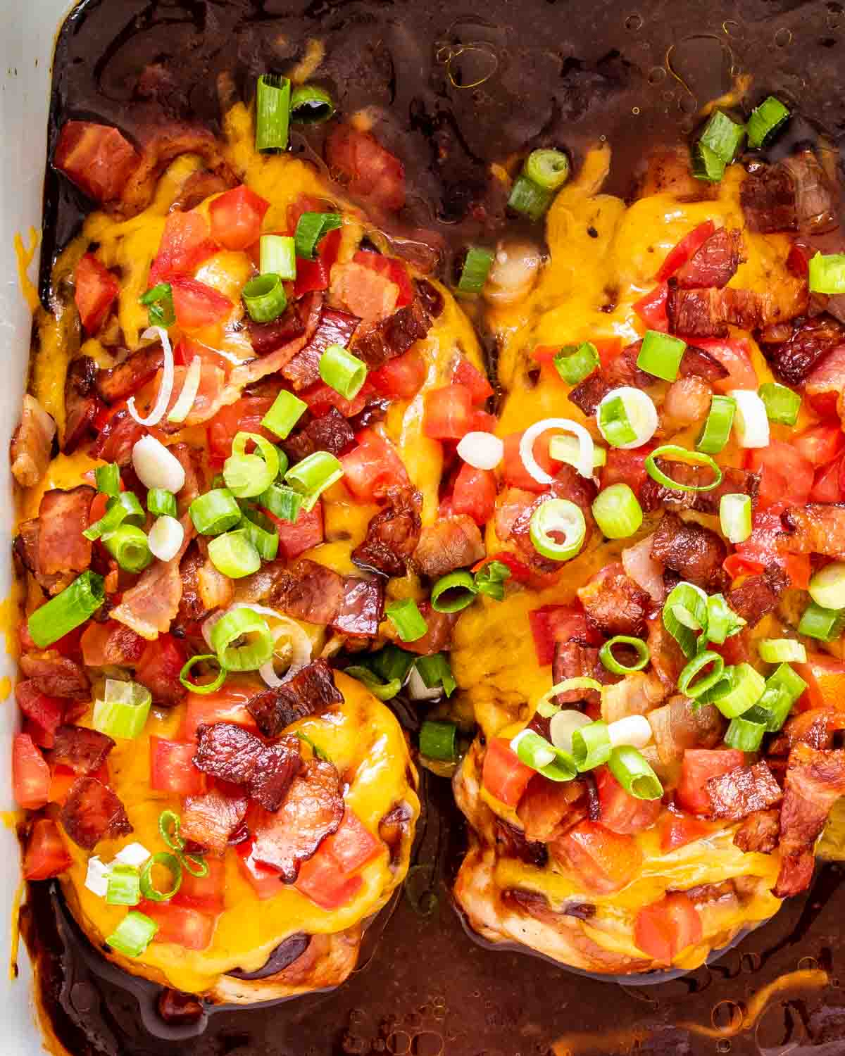 closeup of 2 pieces of monterey chicken breasts in a baking dish.