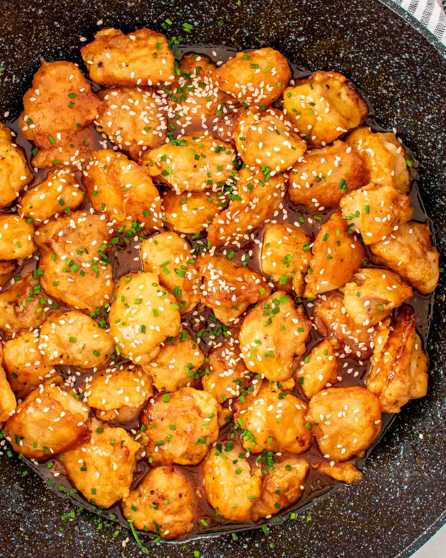 freshly made orange chicken in a wok.