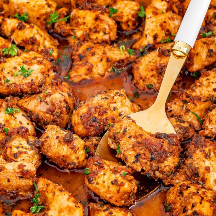 fresh out of the oven oven baked chicken bites in a white baking dish.