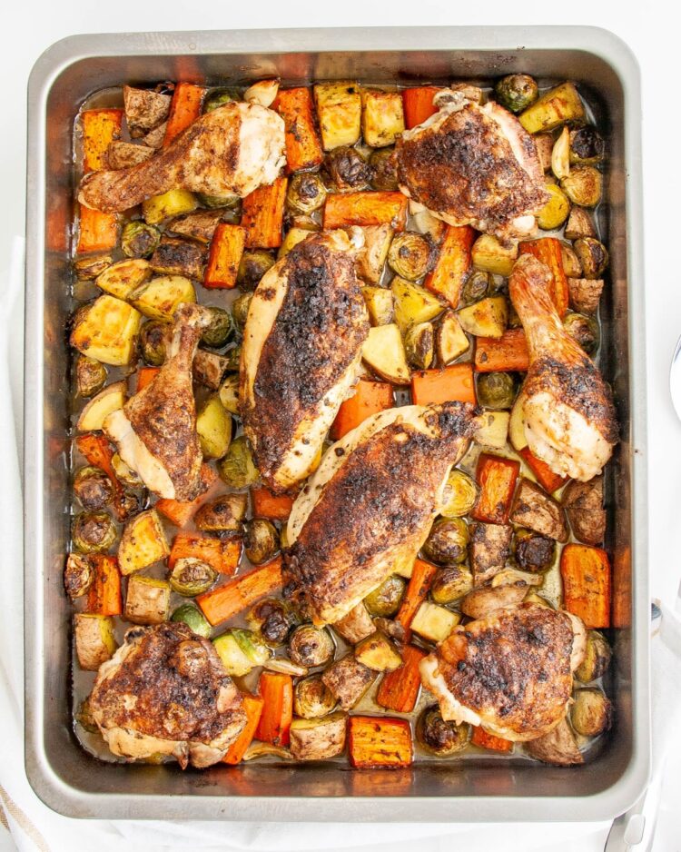 overhead shot of roasted chicken and vegetables in a roasting pan