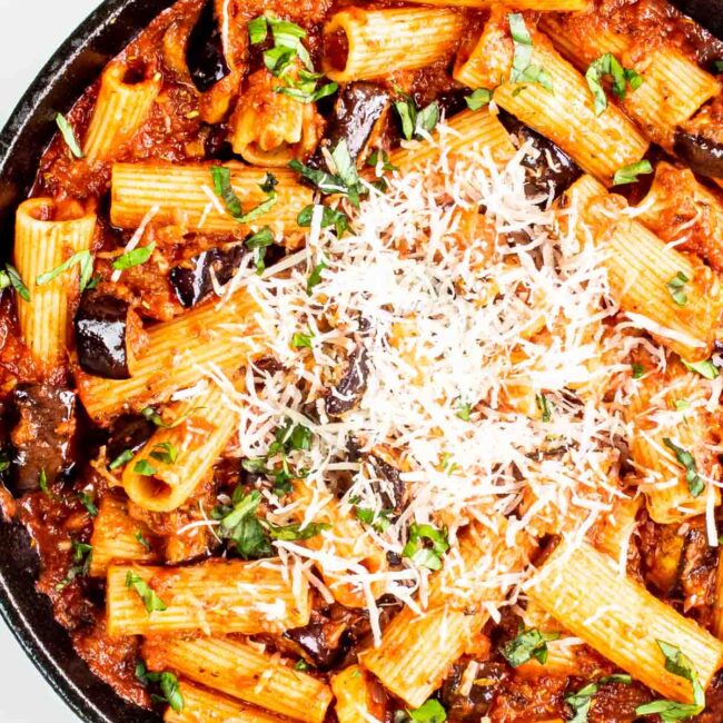 freshly made pasta alla norma in a black skillet.