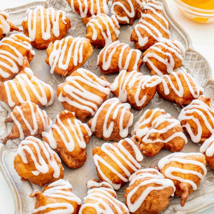 glazed peach fritters on a serving platter.