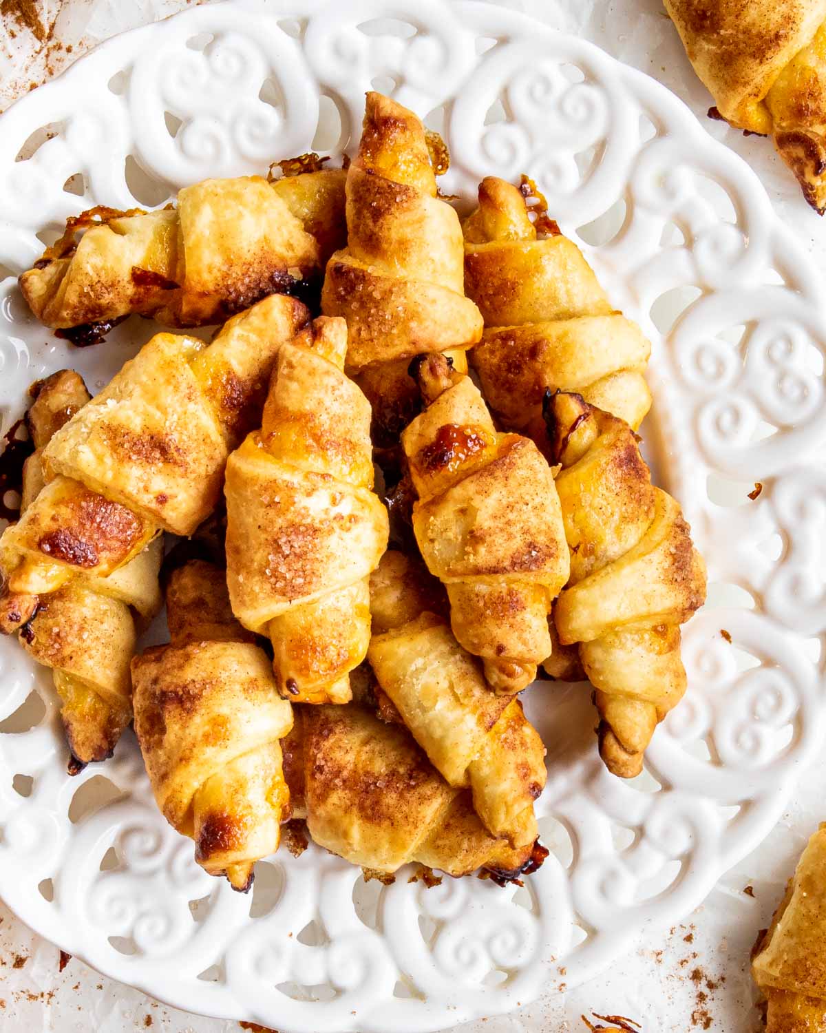 a few rugelach cookies on a white plate.
