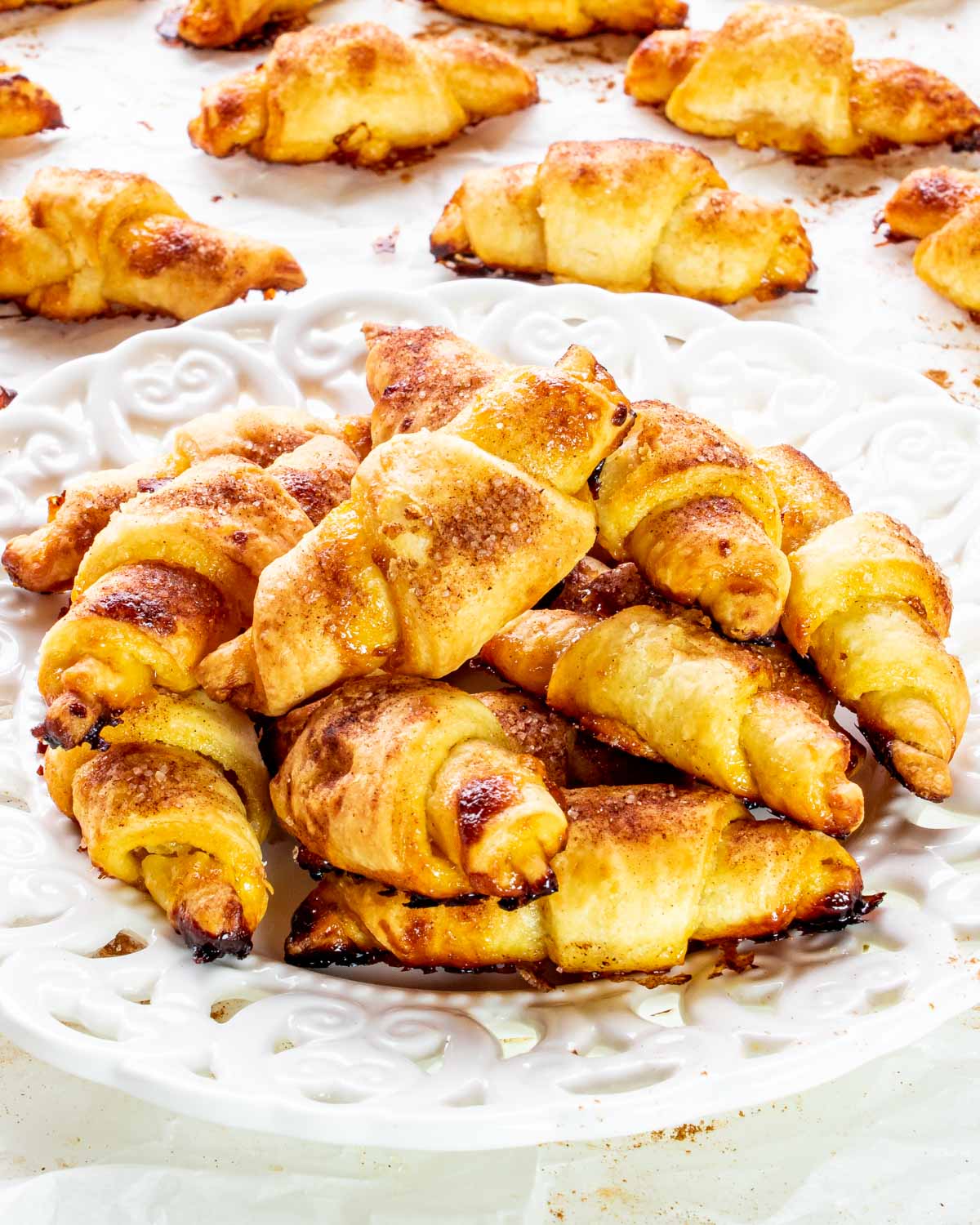 a few rugelach cookies on a white plate.