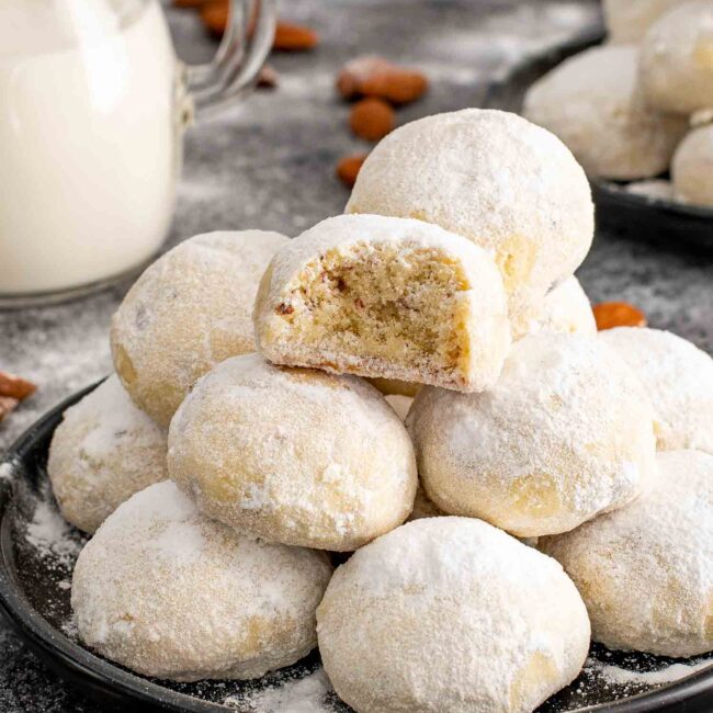 a plate with a stack of russian tea cakes.