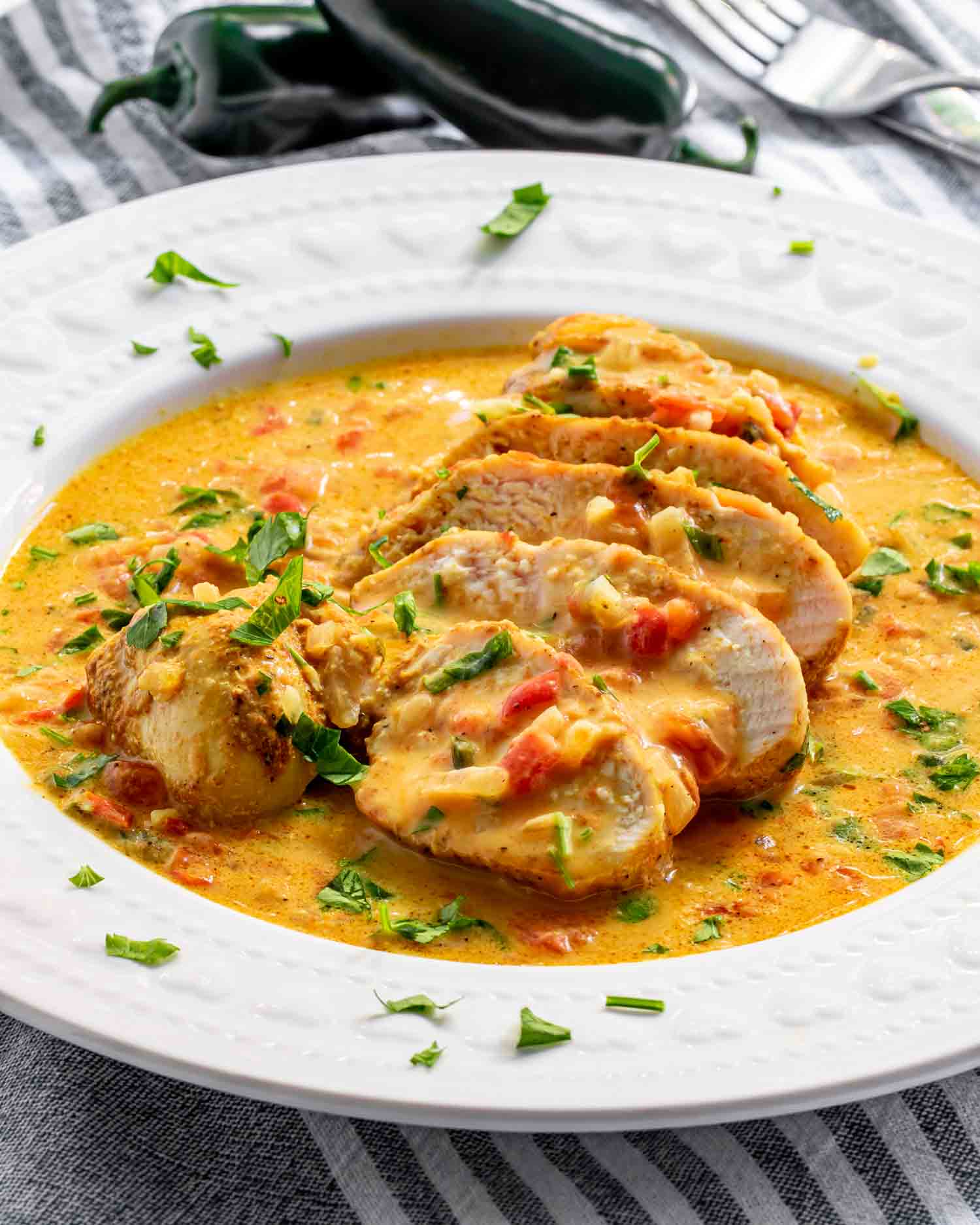 a serving of spicy brazilian coconut chicken on a white plate.