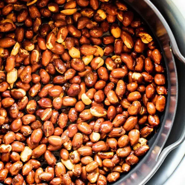 roasted peanuts in an air fryer basket.