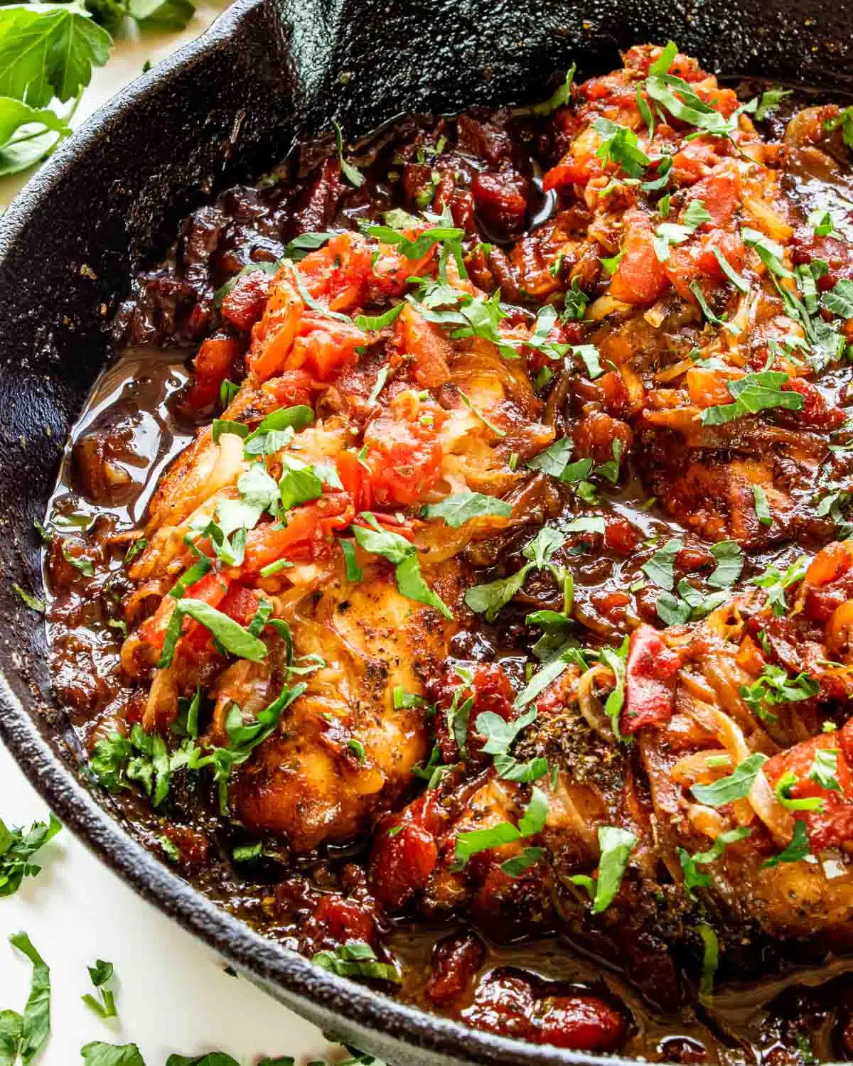 freshly made braised balsamic chicken in a skillet.
