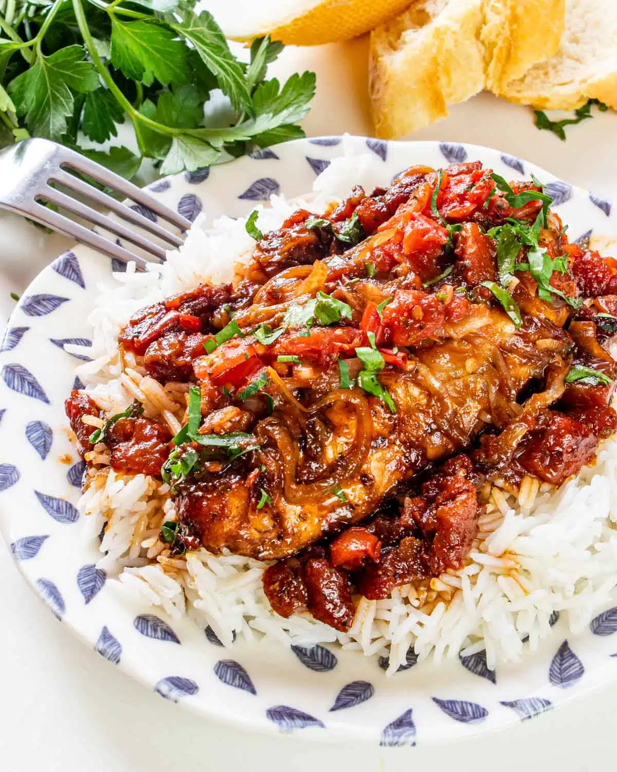 a braised balsamic chicken breast on a bed of rice.
