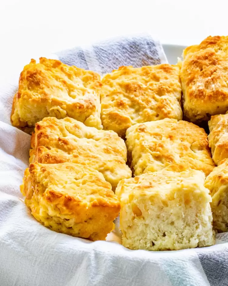 a bunch of fresh butter biscuits in a basket