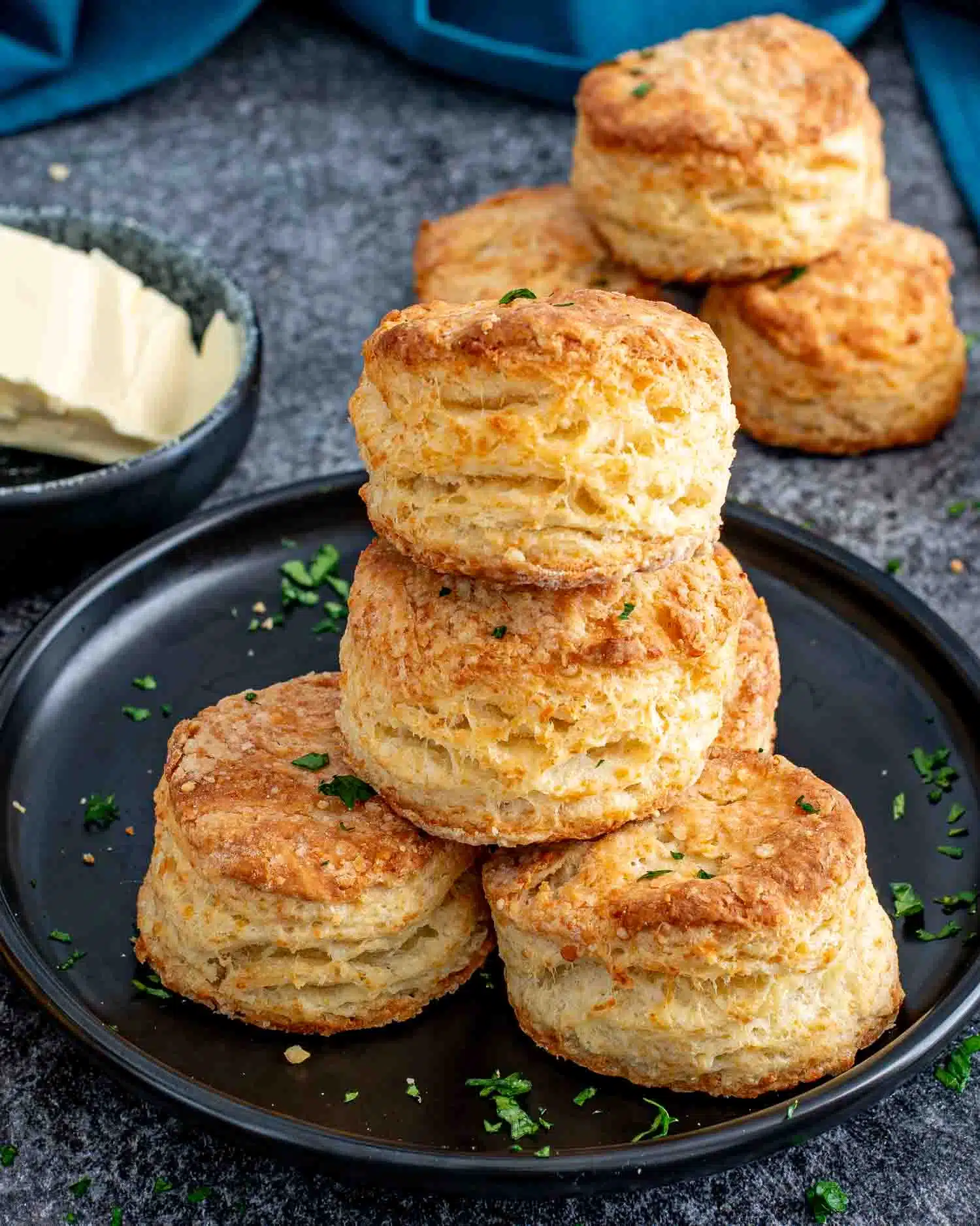a stack of freshly baked buttermilk parmesan biscuits.