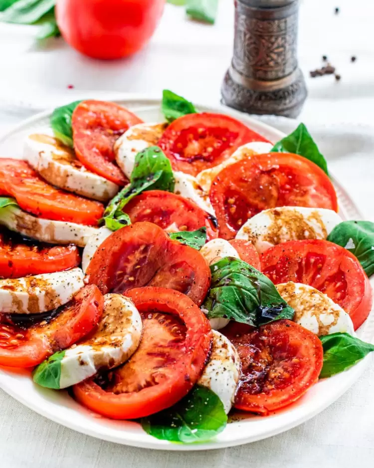 caprese salad on a white platter