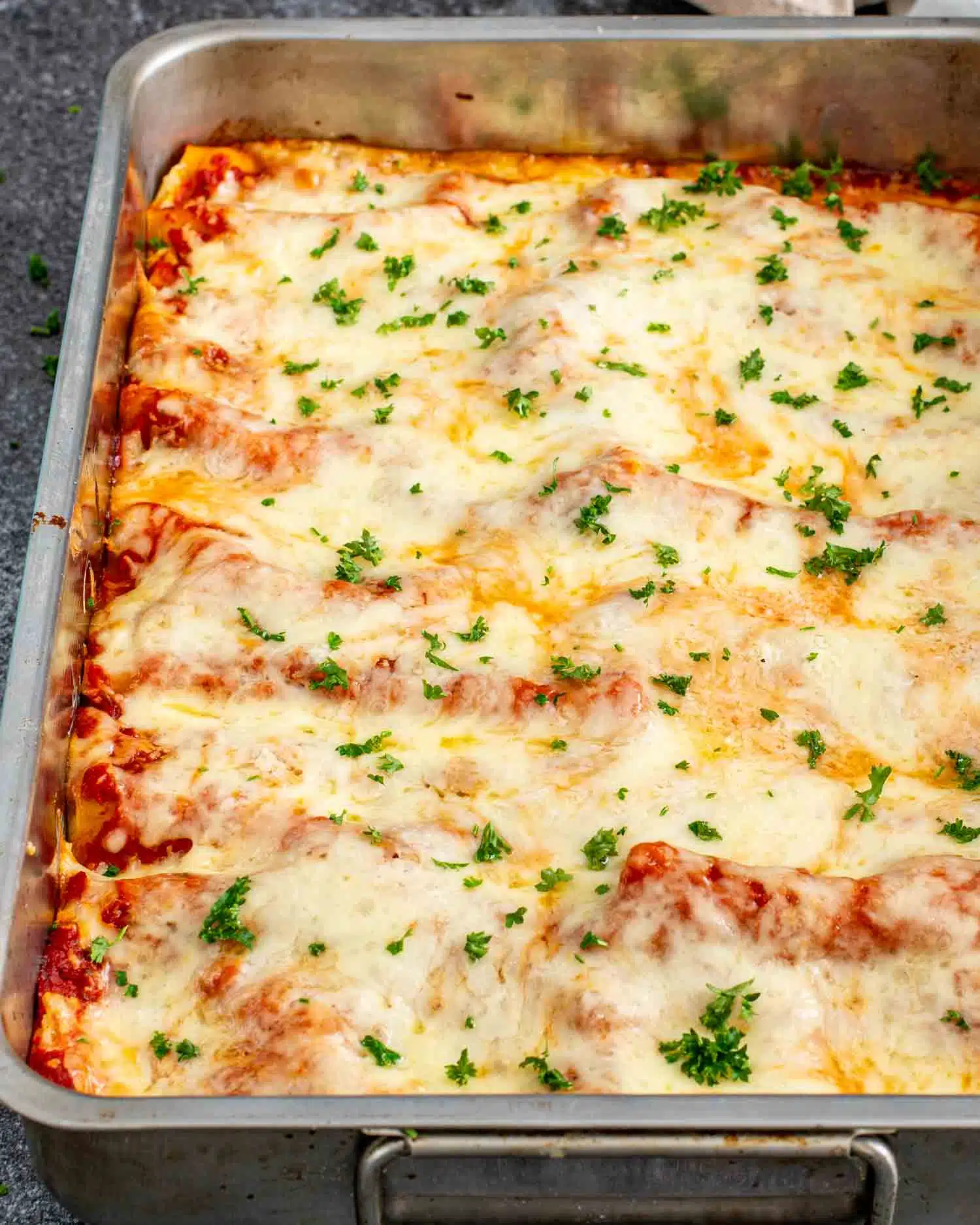 freshly made cheese stuffed manicotti in a casserole dish.