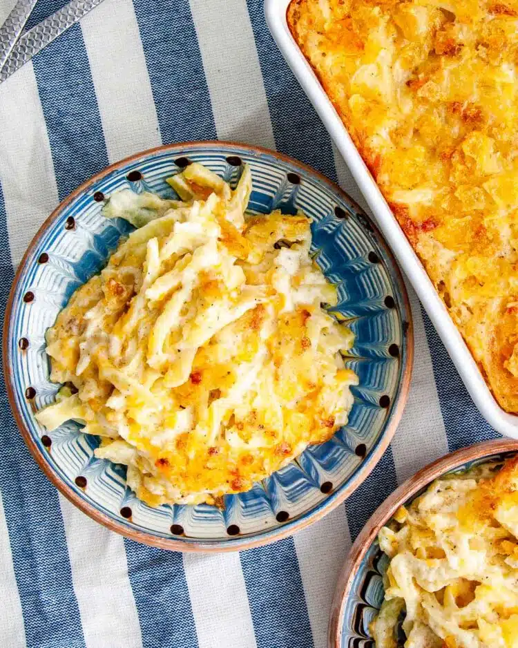 overhead shot of a couple plates loaded up with cheesy potato casserole