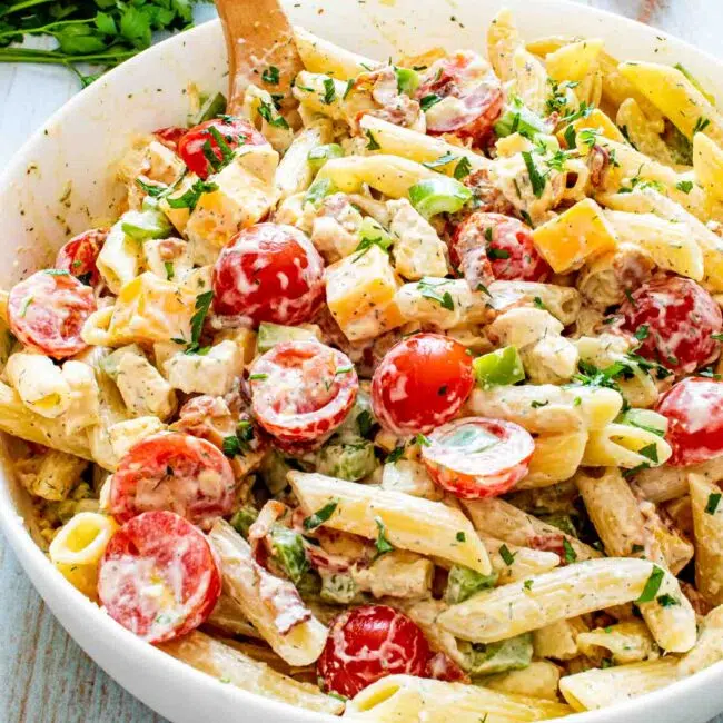 chicken club pasta salad in a white bowl.