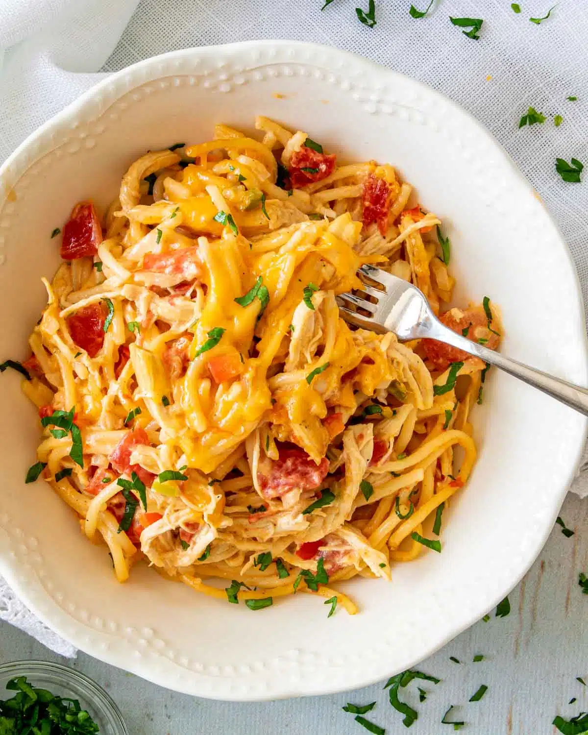 freshly made chicken spaghetti in a white bowl.