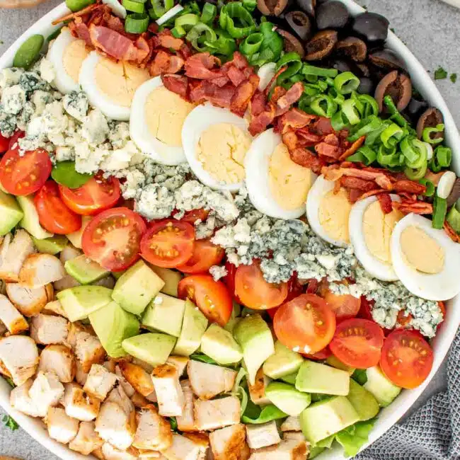 A fresh and colorful Cobb salad arranged beautifully in a bowl.