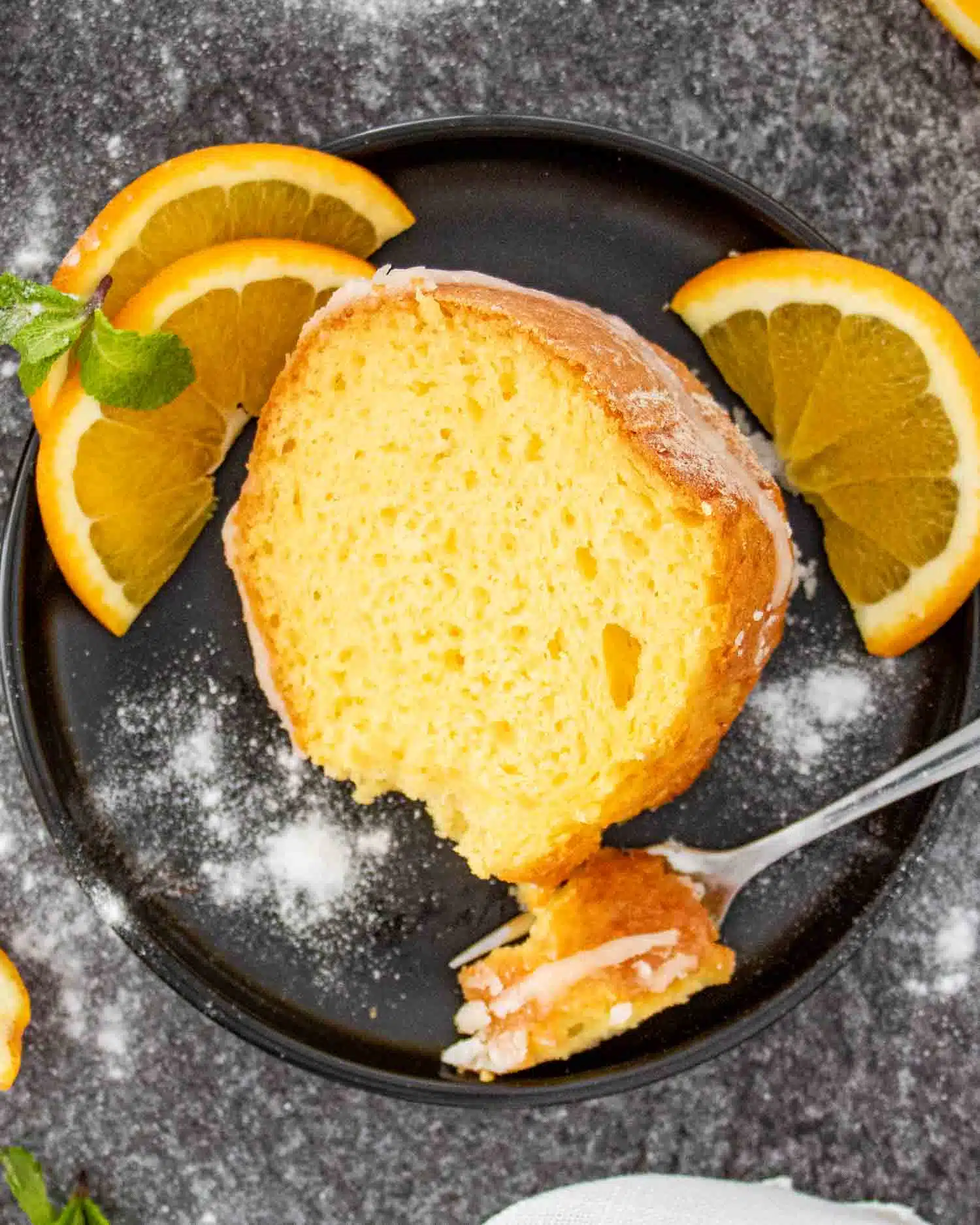 a slice of harvey wallbanger cake on a black plate.