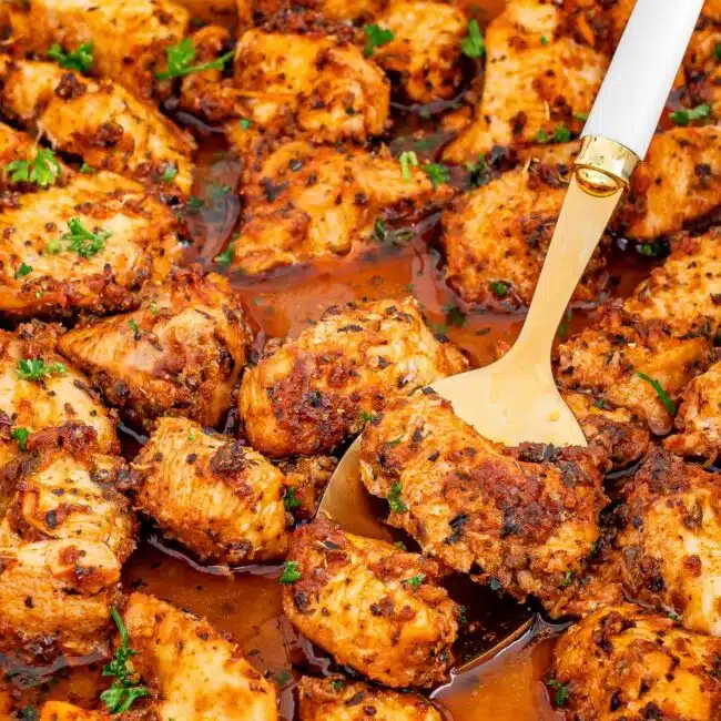 fresh out of the oven oven baked chicken bites in a white baking dish.