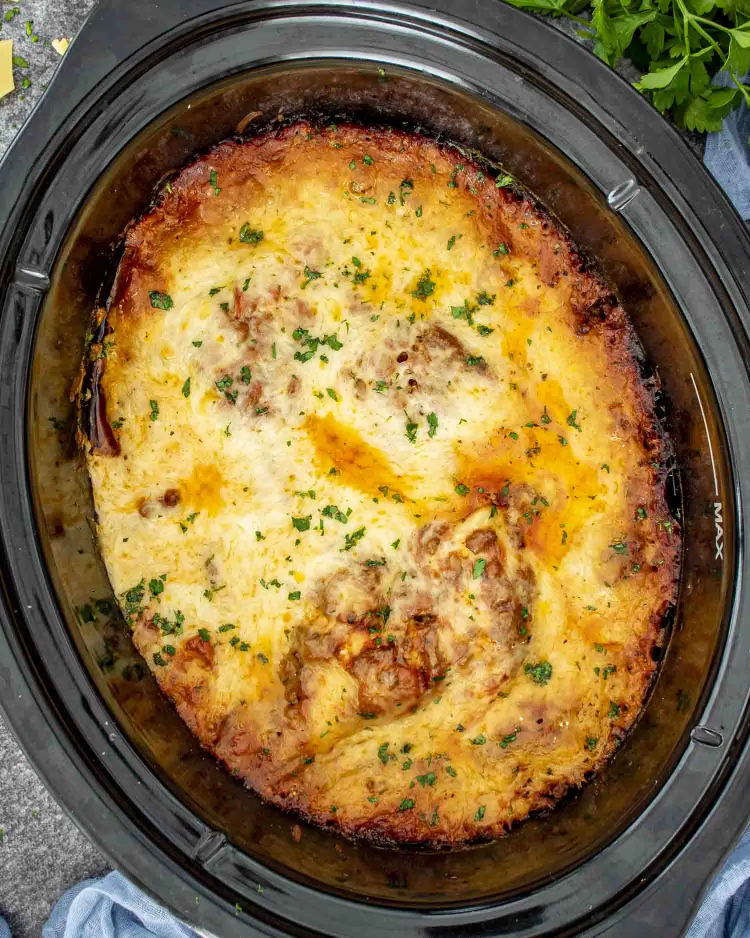 freshly made slow cooker lasagna garnished with a bit of parsley.